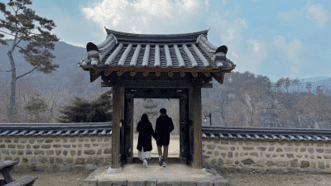 분강서원 문을 지나며 산 풍경을 바라보는 두 사람